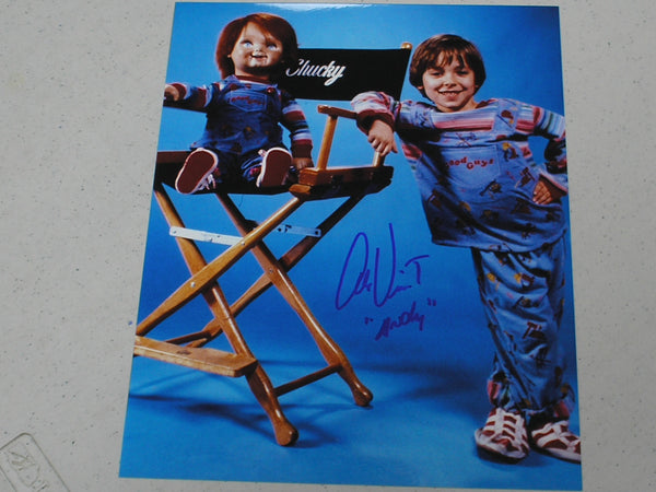 Alex Vincent signed 8x10 photo as Andy from Child's Play, featuring Chucky in the background, JSA COA G certified.